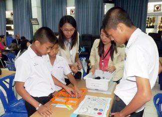 Teachers and students begin the process of learning how to assemble a robot.